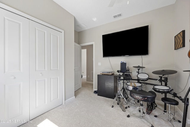 interior space with light colored carpet and ceiling fan