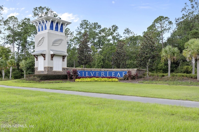 community sign featuring a lawn