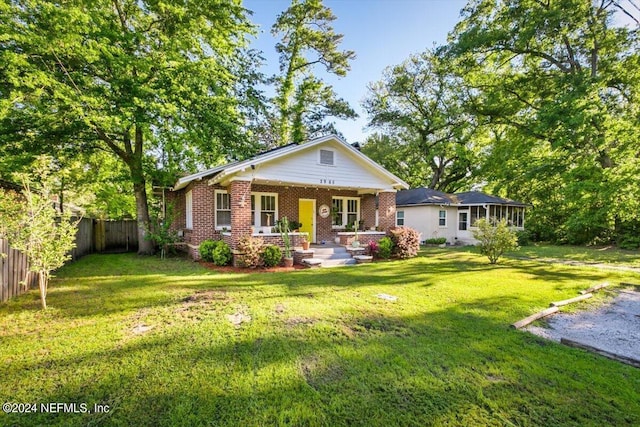 view of front of house with a front lawn and covered porch