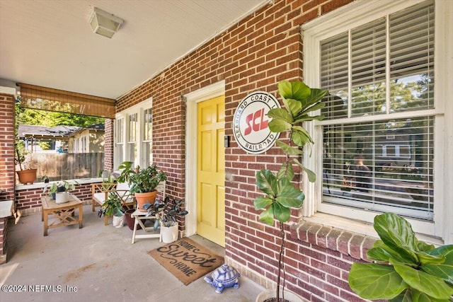 view of exterior entry with a porch