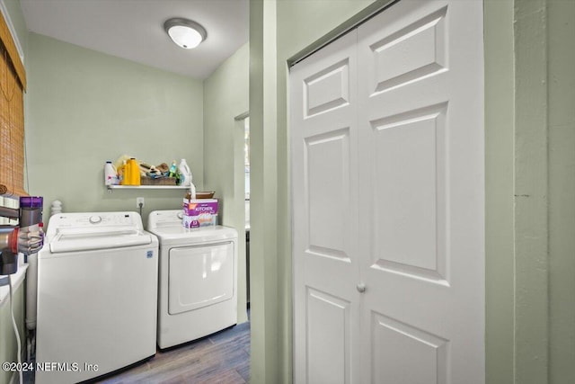 laundry room with separate washer and dryer and light hardwood / wood-style flooring