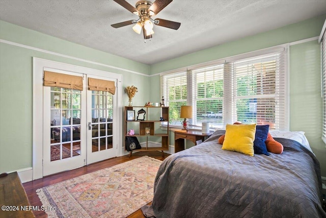 bedroom with wood-type flooring, a textured ceiling, and ceiling fan