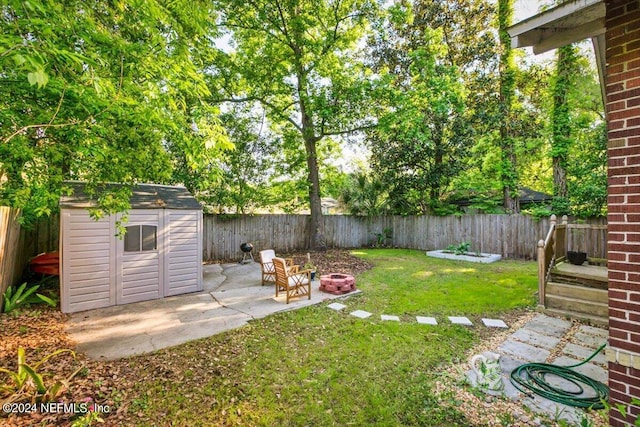 view of yard with a patio area and an outdoor fire pit