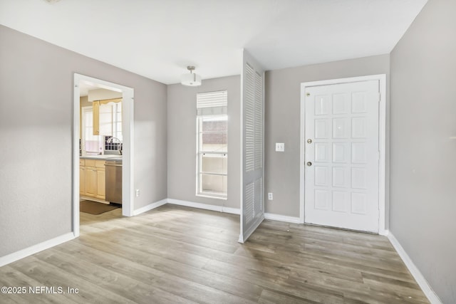 entrance foyer featuring baseboards and light wood finished floors