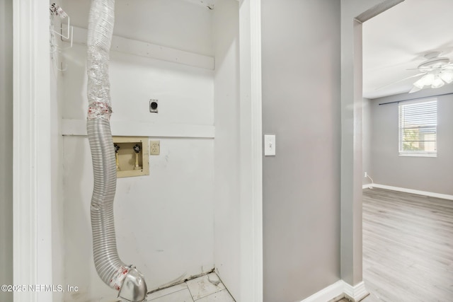 interior space with hookup for a washing machine, hookup for an electric dryer, laundry area, baseboards, and light wood-style floors