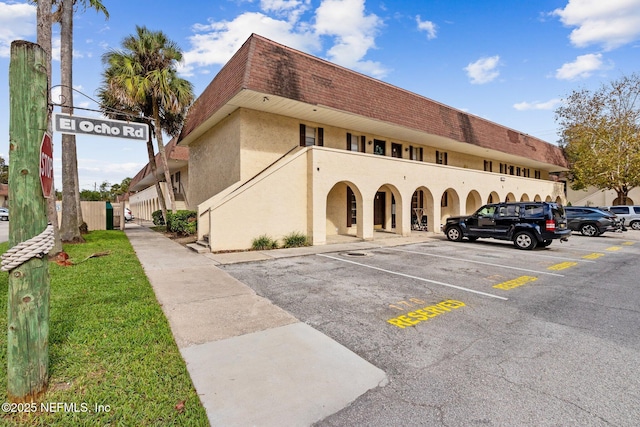 view of property with uncovered parking