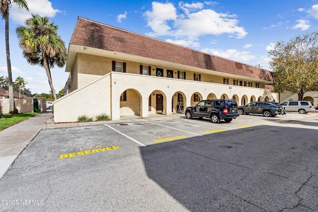 view of building exterior featuring uncovered parking