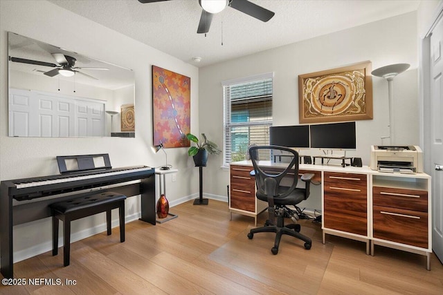 office with ceiling fan, light hardwood / wood-style floors, and a textured ceiling