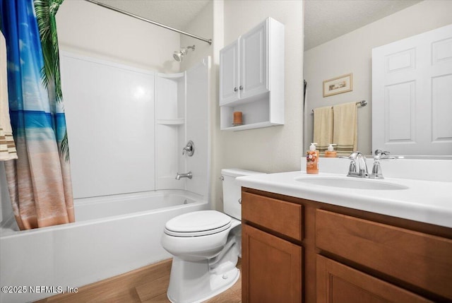 full bathroom featuring shower / bath combo, vanity, a textured ceiling, hardwood / wood-style flooring, and toilet