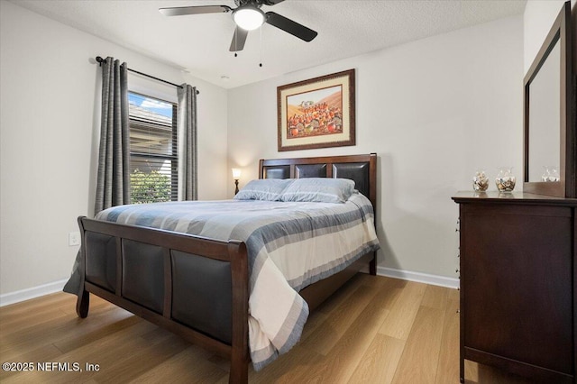 bedroom with ceiling fan and light wood-type flooring