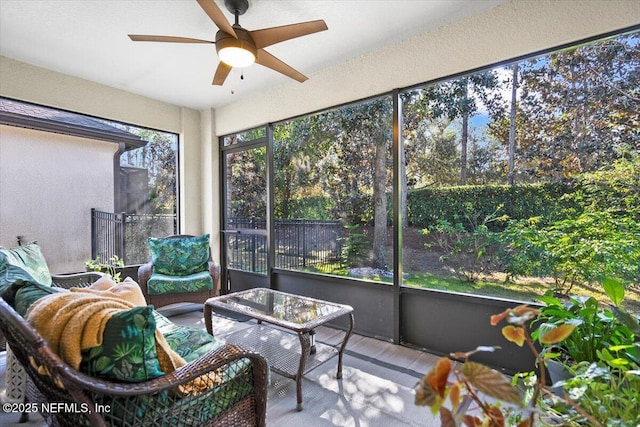 sunroom / solarium featuring ceiling fan