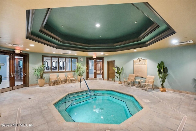 view of swimming pool featuring an indoor in ground hot tub and french doors