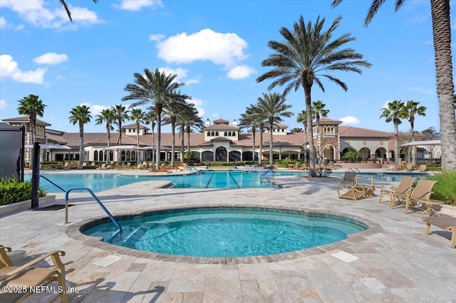 view of pool with a hot tub