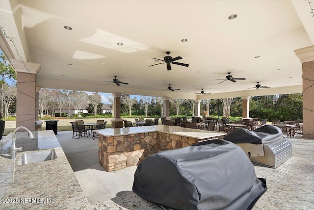 view of patio with a grill and an outdoor wet bar