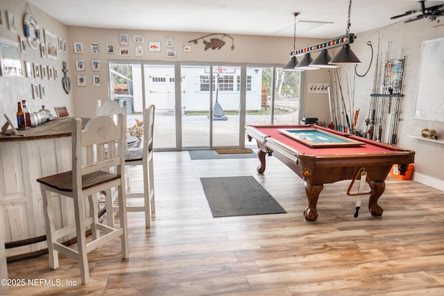 rec room with light hardwood / wood-style floors and billiards