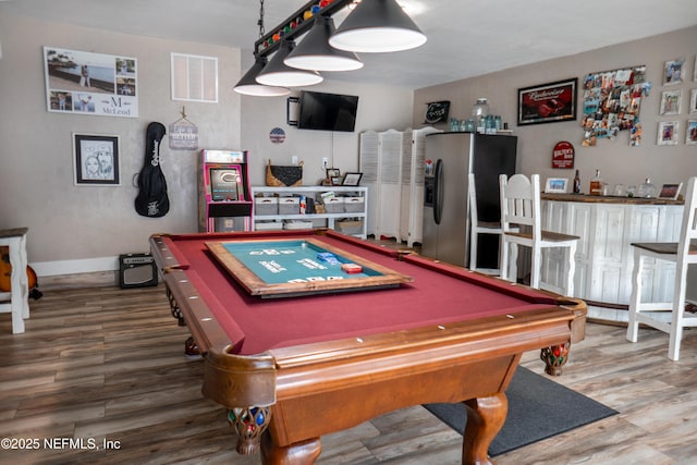 recreation room featuring bar, wood-type flooring, and pool table