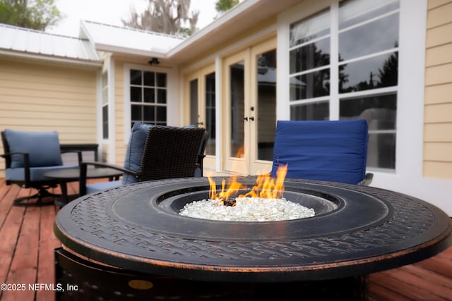 deck featuring french doors and an outdoor fire pit