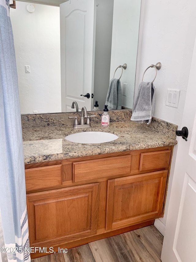 bathroom with wood-type flooring and vanity