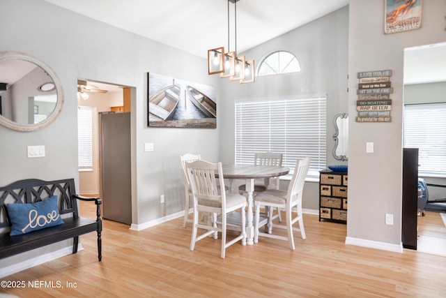 dining room with light wood-style floors, baseboards, and a ceiling fan