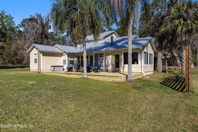 view of front facade with metal roof, a patio area, and a front yard