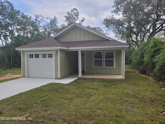 view of front of home with a garage and a front lawn