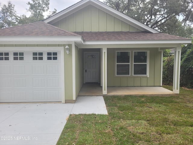 view of front of property with a front yard and a garage