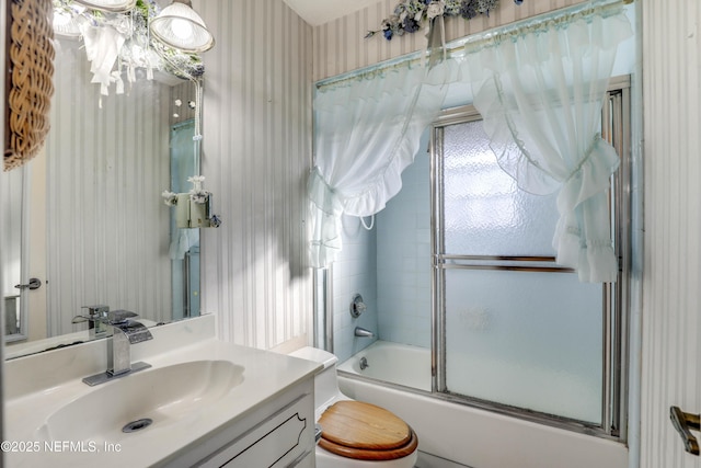 full bathroom with vanity, toilet, and shower / bath combination with glass door