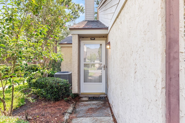 entrance to property featuring cooling unit