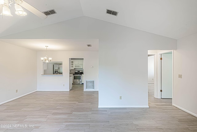 empty room with a chandelier and lofted ceiling