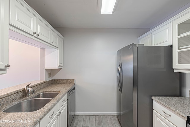 kitchen featuring white cabinetry, sink, and appliances with stainless steel finishes