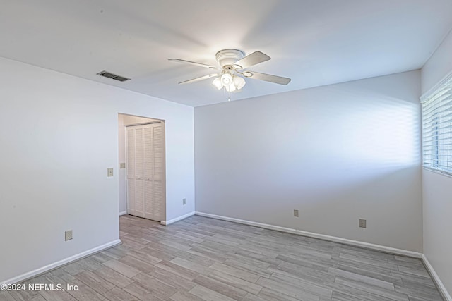 unfurnished room with light hardwood / wood-style flooring and ceiling fan