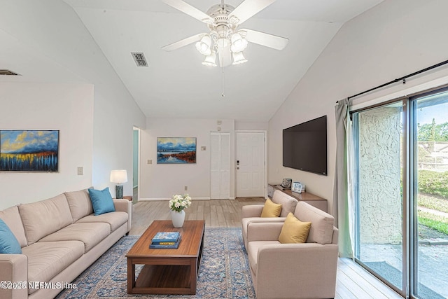 living room featuring ceiling fan, light wood-type flooring, and lofted ceiling