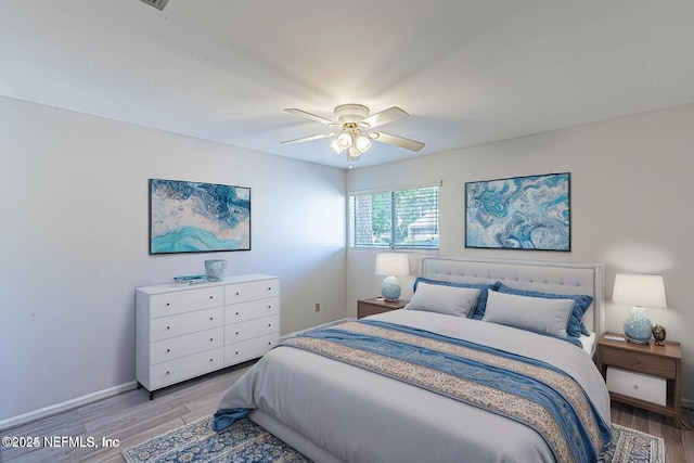 bedroom with ceiling fan and light hardwood / wood-style flooring