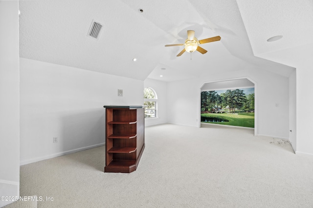 additional living space featuring light colored carpet, ceiling fan, and lofted ceiling