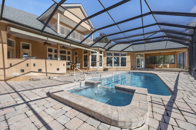 view of swimming pool featuring ceiling fan, a lanai, and exterior bar