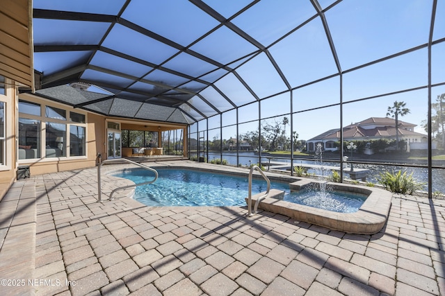 view of pool with glass enclosure, an in ground hot tub, a patio area, and a water view