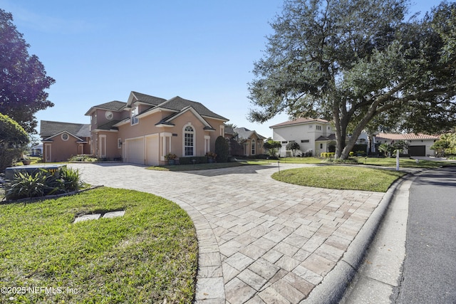 view of front of home featuring a garage and a front lawn