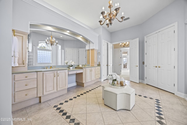 bathroom with vanity, tile patterned floors, and a notable chandelier