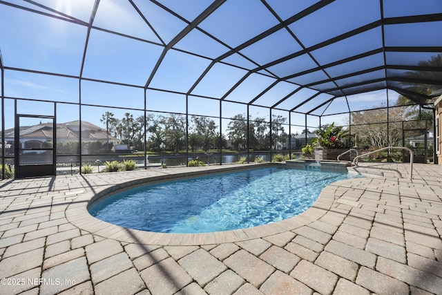 view of swimming pool with glass enclosure and a patio