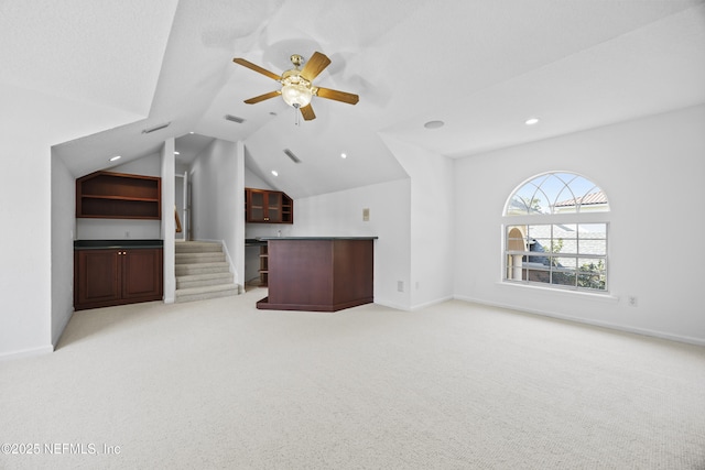 unfurnished living room featuring light carpet, ceiling fan, and lofted ceiling