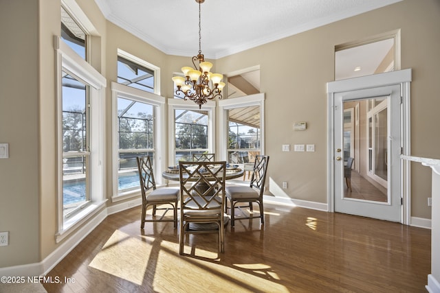 dining room featuring a chandelier, ornamental molding, and dark wood-type flooring