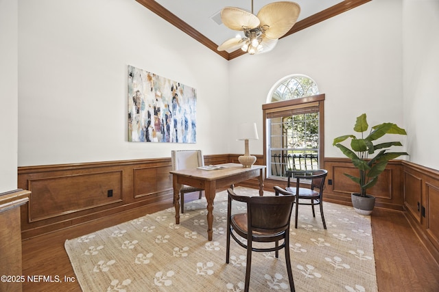 office area featuring dark hardwood / wood-style flooring, ceiling fan, and crown molding