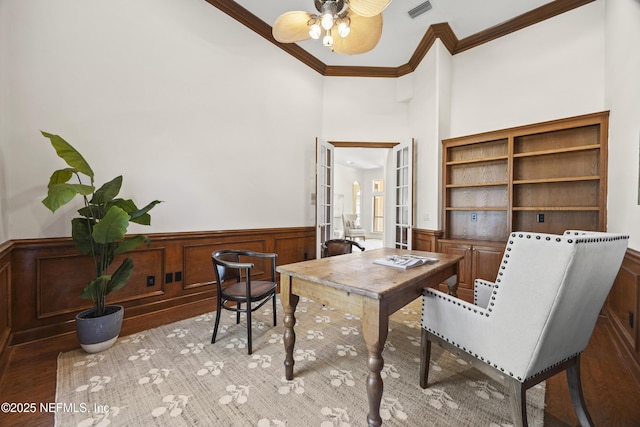 office area with ceiling fan, light hardwood / wood-style floors, crown molding, and french doors