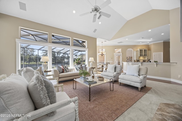 living room featuring carpet, ceiling fan with notable chandelier, and high vaulted ceiling