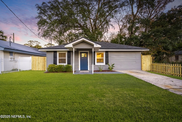 ranch-style home with a lawn