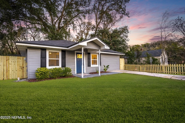 ranch-style house featuring a yard