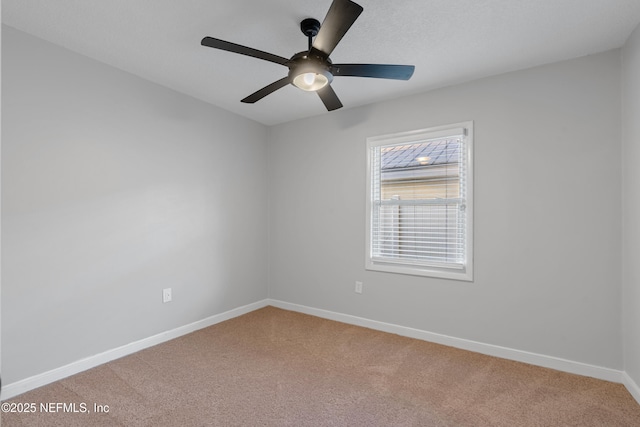 spare room featuring carpet floors and ceiling fan