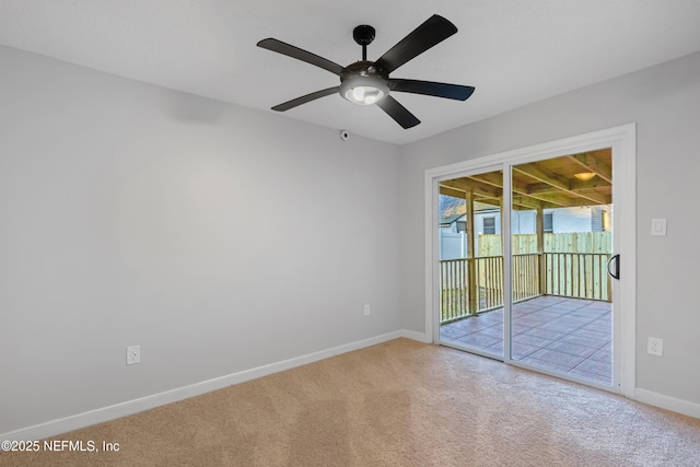 carpeted spare room with ceiling fan