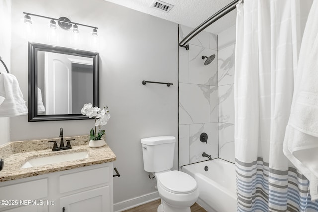 full bathroom featuring a textured ceiling, vanity, shower / tub combo, and toilet