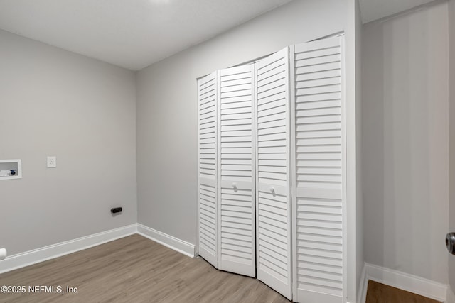 laundry room with hookup for a washing machine and light hardwood / wood-style floors